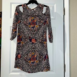 Cream dress with multi color floral design.